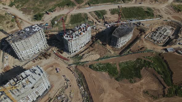 Construction site for a new city block. Construction work is underway. alt