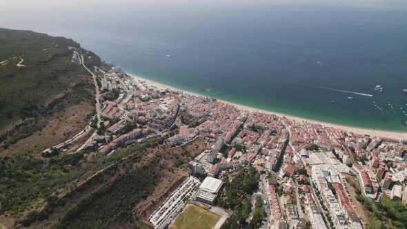 Aerial circle view from above of wonderful sea of Sesimbra, Portugal. Real time alt