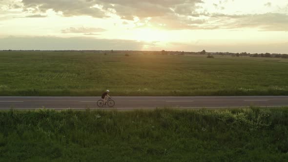 A Sportsman is Riding a Bicycle alt