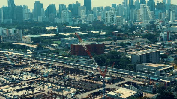 Panoramic view of cityscape and construction site in metropolis