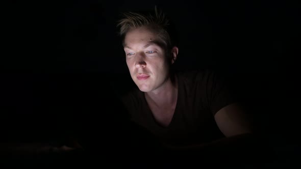 Young Handsome Scandinavian Man Using Digital Tablet in Dark Room