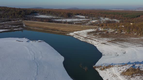 Flight Over A Dam On A Snowy Winter Day  alt