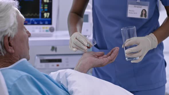 Nurse Giving Pills to Patient alt