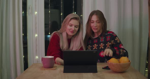 Young Women at Xmas Using Tablet Video Call