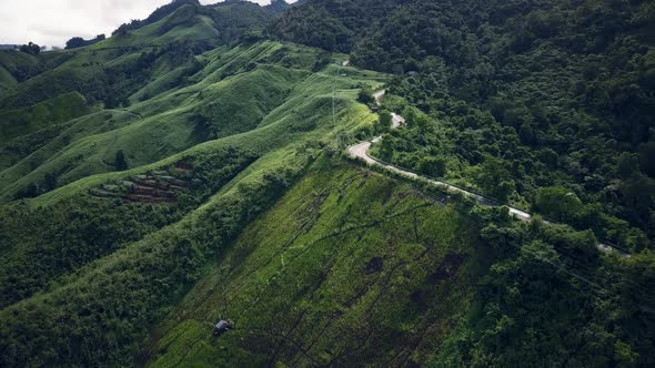 Countryside Road Passing Through The Mountain Landscape  alt
