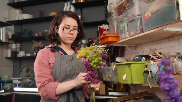 Asian Florist Saleswoman Creating Bouquet. Florist Arranding Flowes. Floral Shop Store. Hobby Work