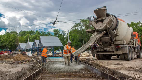 Concrete Works for Road Construction with Many Workers and Mixer Timelapse alt