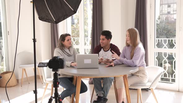 A group of people creating content for a social media network while making a video. alt