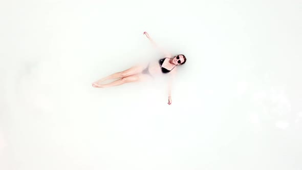 Woman Floating in White Water on Resort