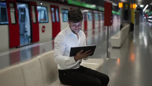 Businessman Using Tablet in Subway alt
