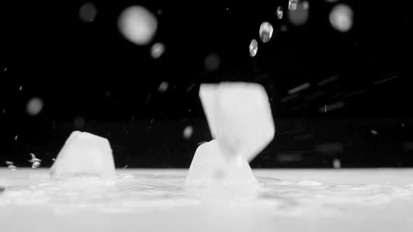 A Cubes Of Ice Falling On Wet Surface