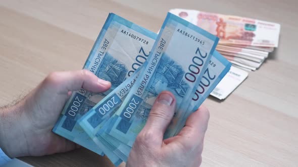 Men's Hands Count Money the Currency is the Russian Ruble