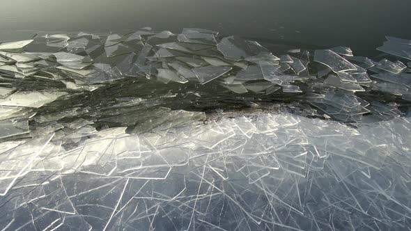 Broken ice sheets moving along the shoreline at Utah Lake alt