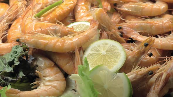 A Closeup of Cooked Shrimps Decorated with Lemon and Lettuce alt