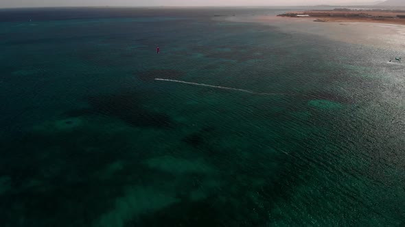 Windsurfer rides on the sea. alt