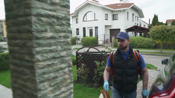 Courier in Medical Gloves Delivers Food To the Customer's Address, the Process of Food Delivery in alt
