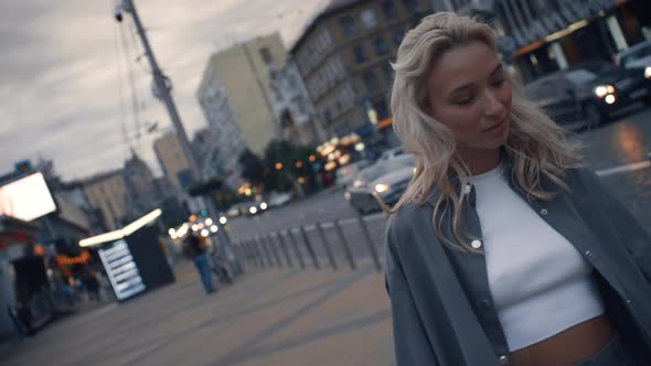 Female Person Walking Street at Evening City Near Dark Road in Urban Area alt