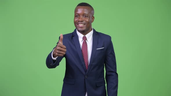 Young Happy African Businessman Giving Thumbs Up alt