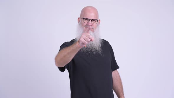 Angry Mature Bald Bearded Man Pointing To Camera alt