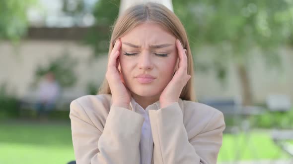 Outdoor Portrait of Young Businesswoman Having Headache alt