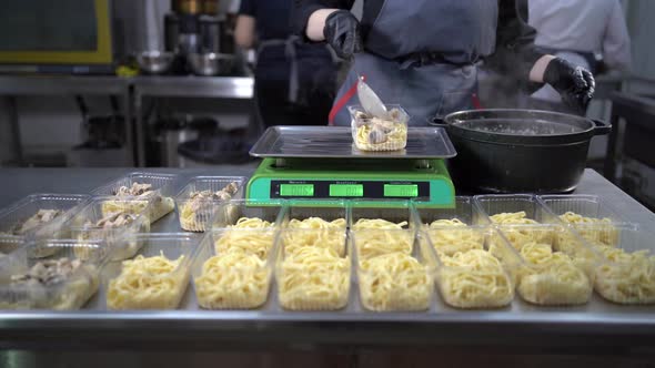 Chef Prepares Takeaway Food in Plastic Containers Pasta and Mushrooms Charity Lunch Small Business alt
