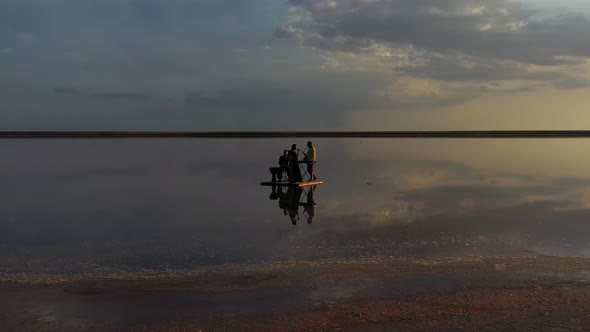 Aerial Footage of Musicians Playing Ethnic Music in the Sea, Reflection Clouds alt