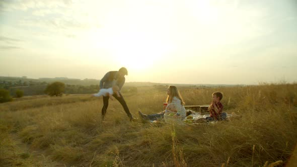 Happy Family Having Fun During Evening Picnic