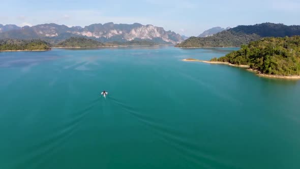 Drone flying straight over Rajjaprabha Dam or Cheow Lan Dam in Ban Cheow Lan, Surat Thani, Thailand alt
