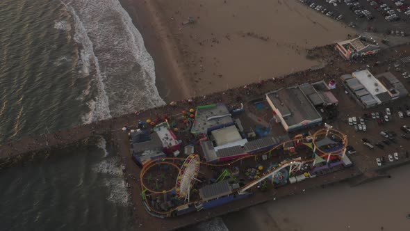 AERIAL Circling Santa Monica Pier California From Above at Beautiful Sunset with Tourists alt