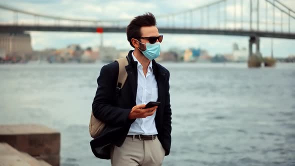 Man In Face Mask In Quarantine City Lockdown.Sad Man In Face Mask At Covid19 Coronavirus New Normal alt