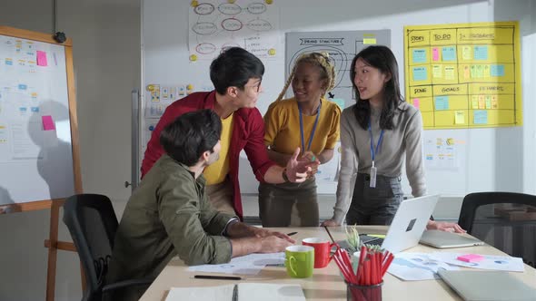 Businessman creative designers present work to the team.Designers a meeting in a modern office. alt