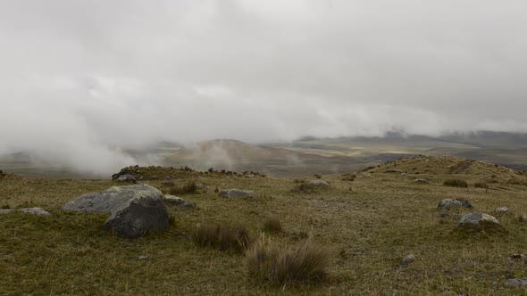 Time lapse of low clouds moving over rocky landscape alt