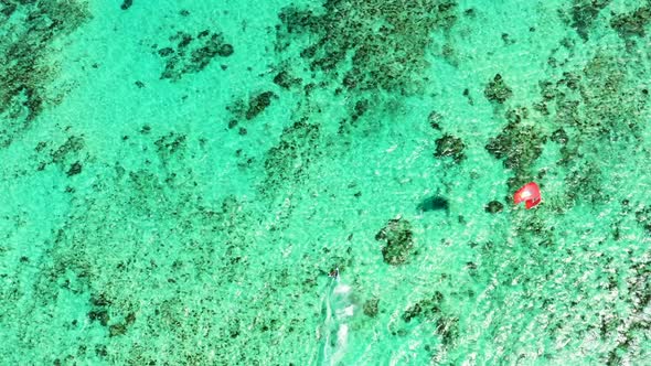 Kitesurfing Le Morne, Mauritius. Drone view flying backwards in front of kite surfer. Kite surfer su alt