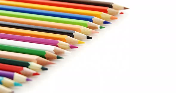 Colored pencils arranged in a row alt