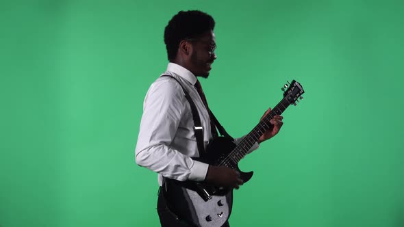 Portrait of Young African American Man Smiling and Playing Electric Guitar alt