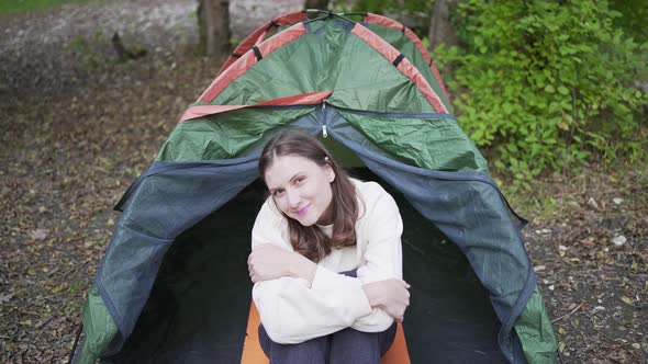 Portrait of a Young Woman Tourist in a Tent