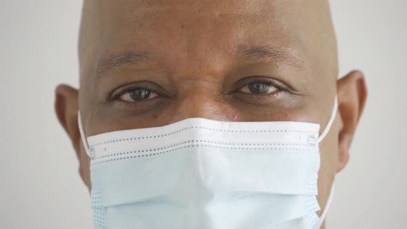 eyes of old elderly black business man. Sick African American person wearing a face mask alt