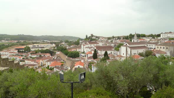 Town and Defensive Wall of Castle of Óbidos on Cloudy Spring Day alt