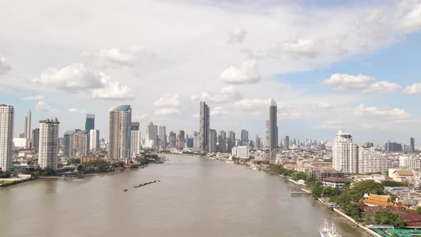 Aerial view of Chao Phraya River with Bangkok Skyscrapers Background on Cloudy day, Thailand alt