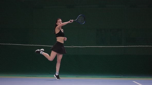 Attractive Slender Female Tennis Player is Training on Indoor Court Hitting Ball By Racquet Slow alt
