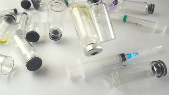 Syringes and falling ampoules. Slow motion. alt