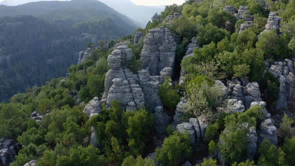 Spectacular Mountain Landscape with Amazing Rock Formations and Green Forests alt