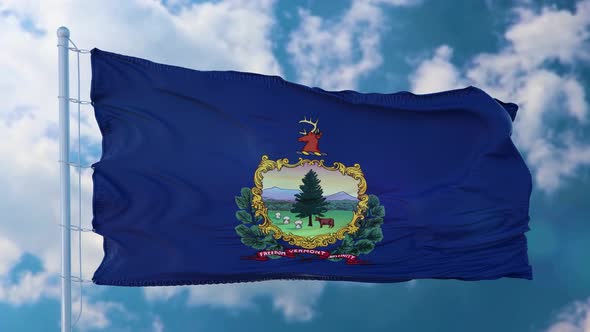 Vermont Flag on a Flagpole Waving in the Wind Blue Sky Background alt