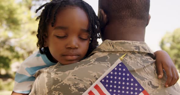 American Soldier is Hugging his Son alt