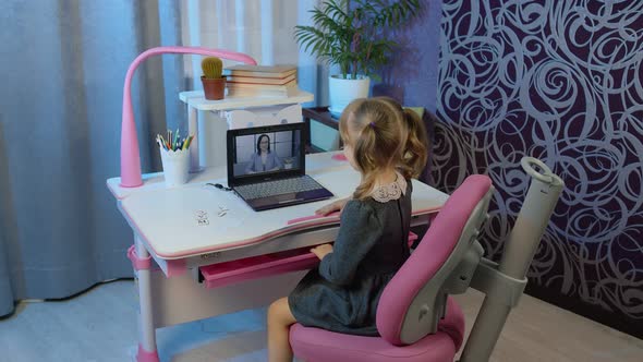 Child Girl Distance Education Homework with Woman Teacher on Laptop Webcam Online Lesson at Home alt
