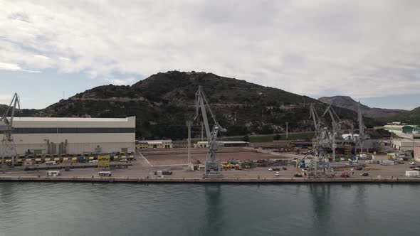 Industrial cranes at dock in Cartagena ready to unload freight; aerial