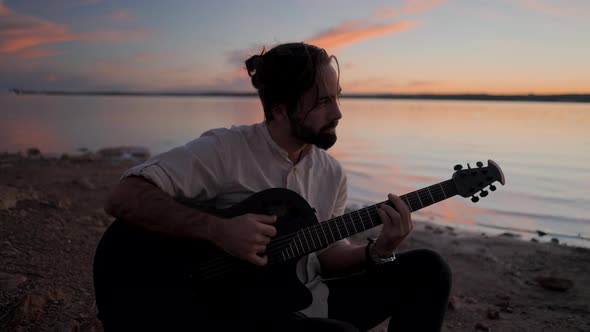 Spanish Bearded Man Playing Guitar By the Torrevieja Pink Lake at Sunset Alicante alt