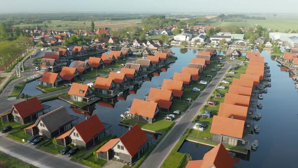 Panorama Of Polder And Luxxury Sustainable Holiday Homes In Netherlands. - aerial pullback alt