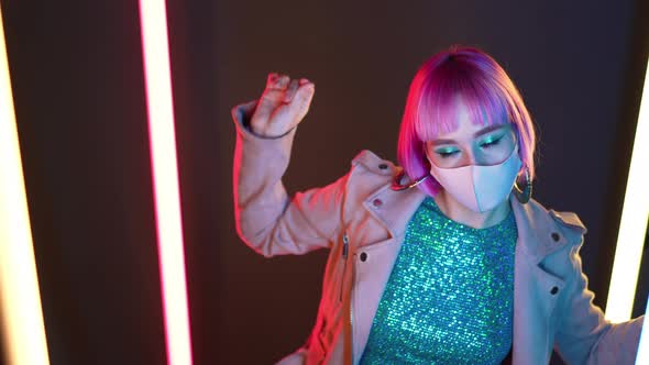 Amazing Woman with Pink Hair and Facial Protective Mask Dancing Alone Between Ledcolorful Bright alt