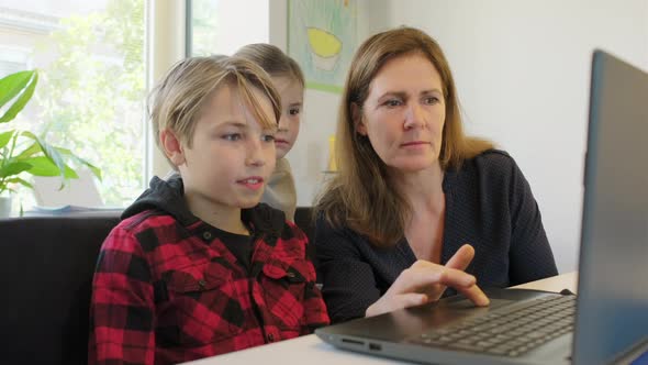 Mother and children with laptop